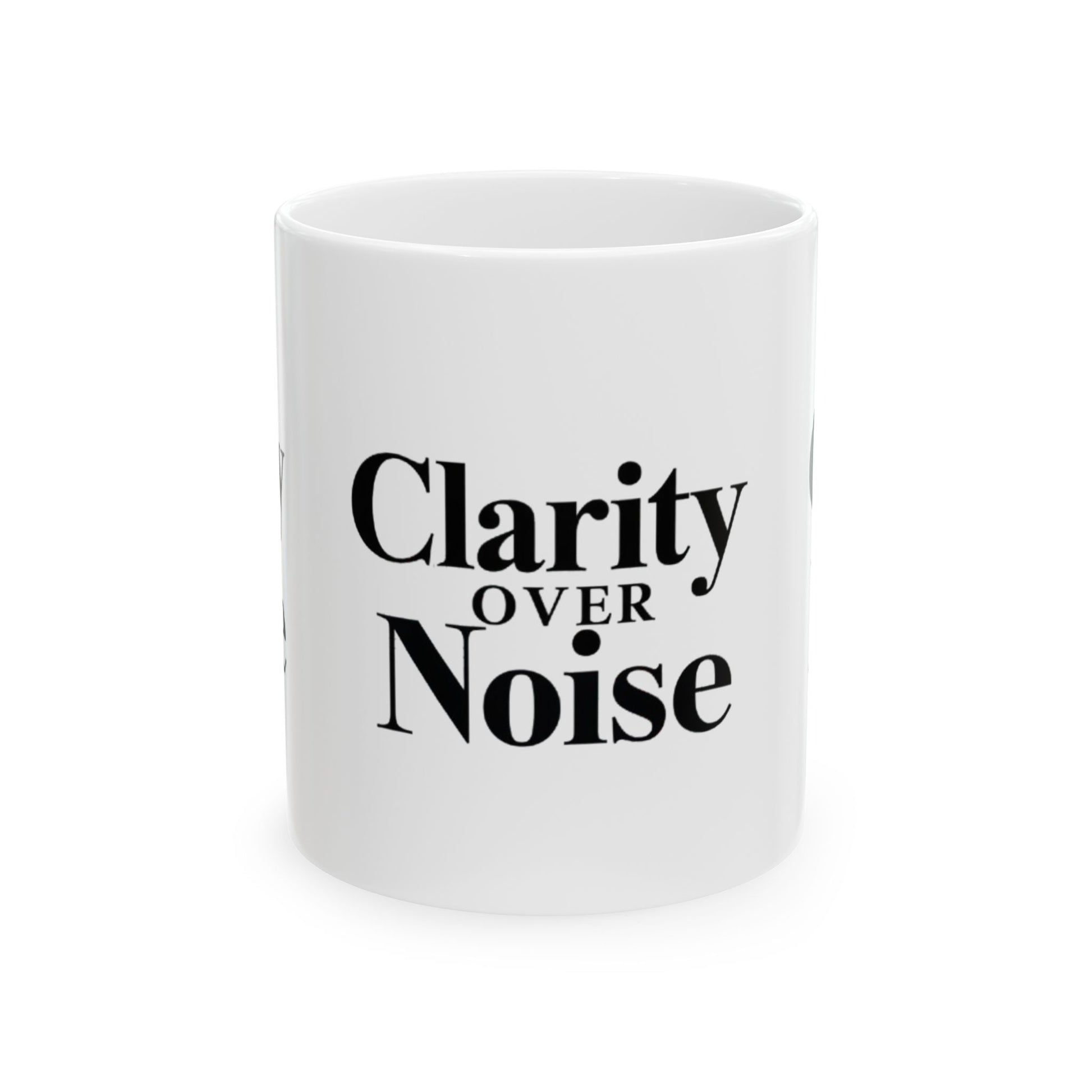 White mug with 'Clarity Over Noise' text on a white background Motivational trading mug next to stock market book on desk with laptop and charts