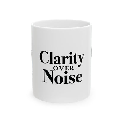 White mug with 'Clarity Over Noise' text on a white background Motivational trading mug next to stock market book on desk with laptop and charts