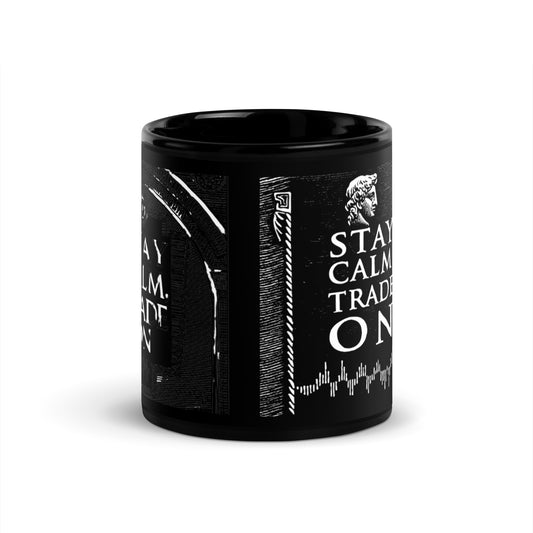 Motivational trading mug next to stock market book on desk with laptop and charts